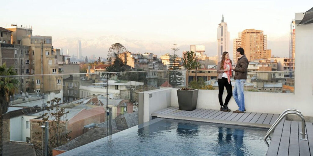 A couple standing atop a luxury hotel in Santiago, Chile.